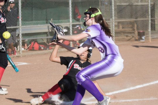 Lemoore's pitcher Ashtyn Lucas attempts to tag out a runner at home in Wednesday's 12-1 loss to Hanford.